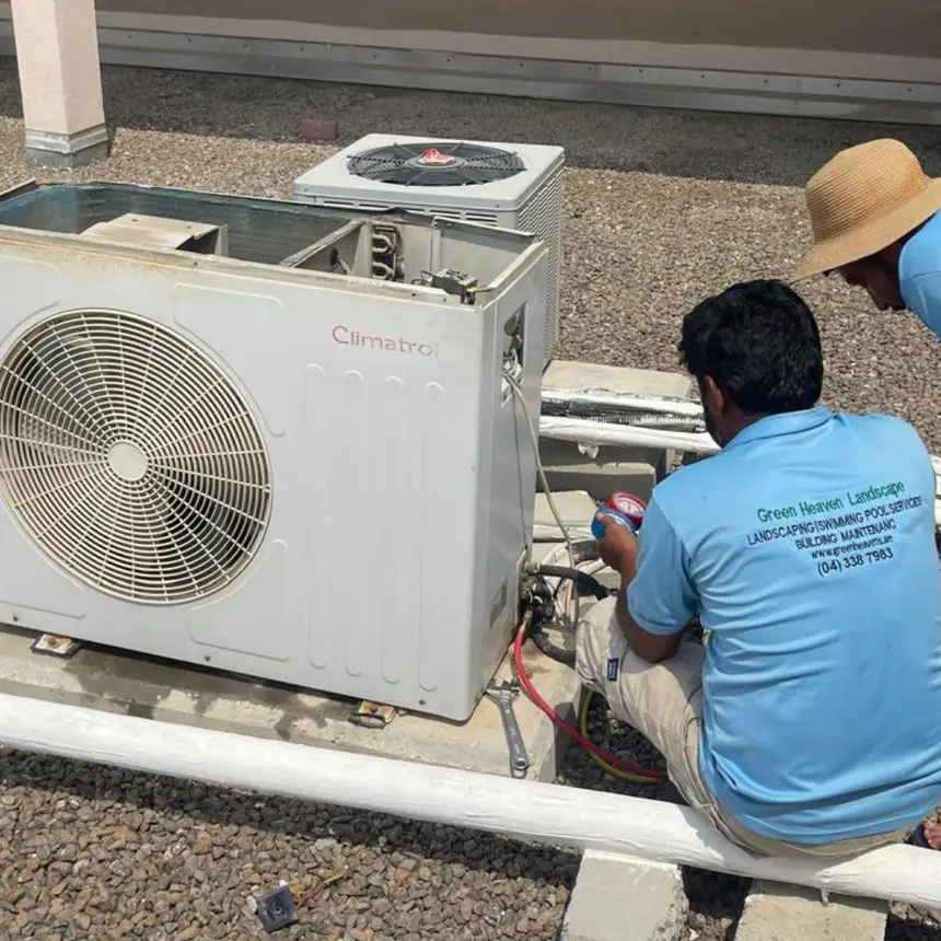 Technicians servicing outdoor air-conditioning units