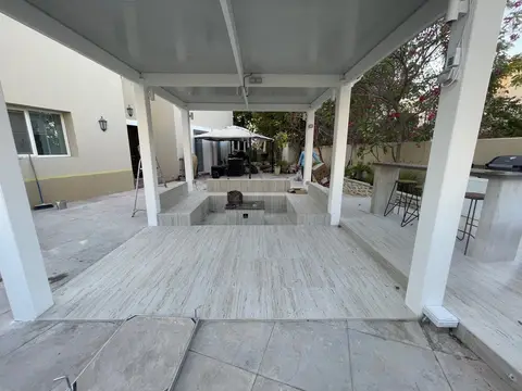 Sunken stone patio with tiled fire feature — architectural hardscape detail