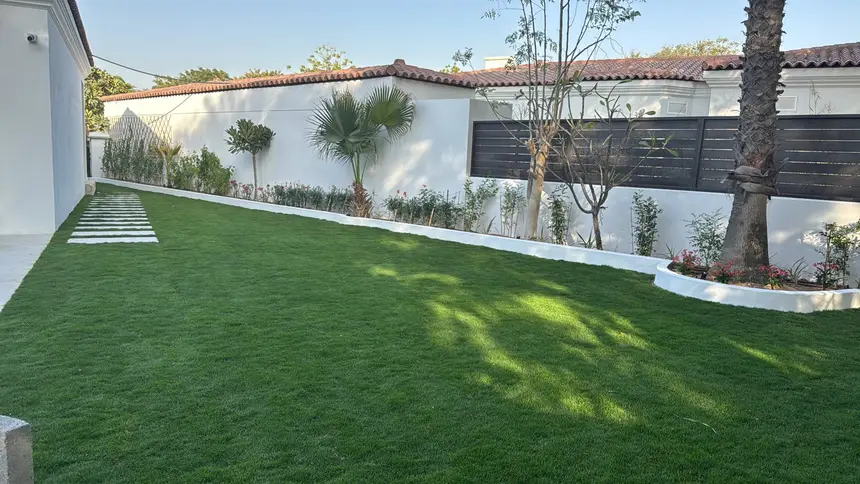 Sloping lawn with stepping stones behind a villa — Green Heaven Landscape project photo