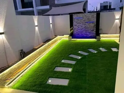 Illuminated turf & water feature at night — Green Heaven Landscape project photo, Dubai