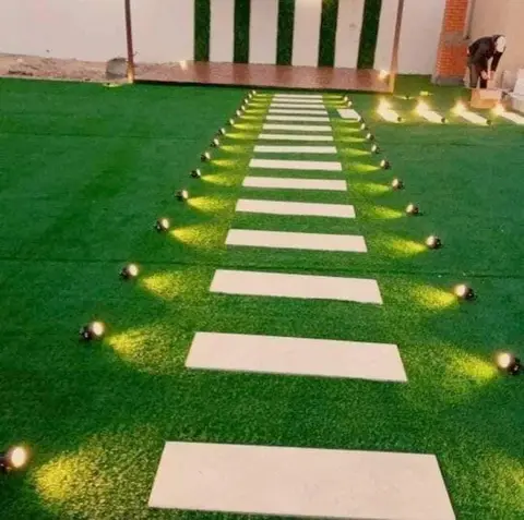 Stone path on lawn with ground lighting — Green Heaven Landscape project photo, Dubai