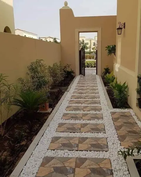 Narrow side yard with stone path & pebbles — Green Heaven Landscape project photo, Dubai