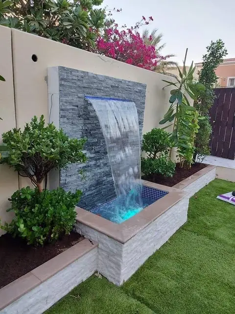 Waterfall with blue-lit basin at dusk