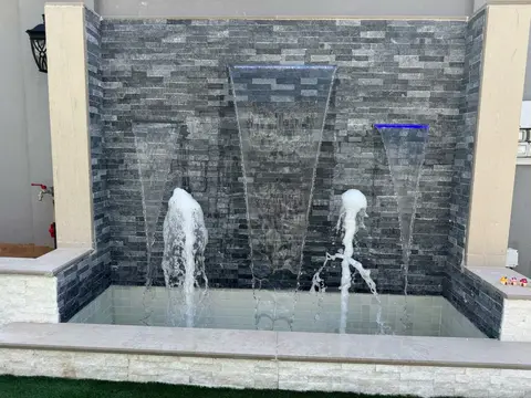 Grey stone triple fountain focal point — Green Heaven Landscape project photo, Dubai